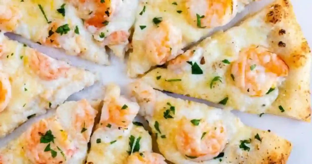 Slices of garlic shrimp pizza topped with shrimp and fresh parsley arranged on a white plate.