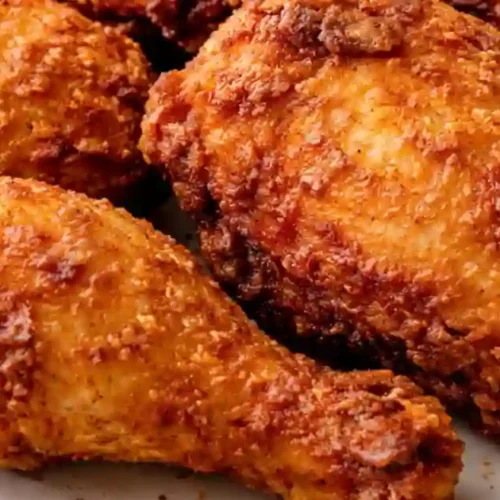 Golden-brown crispy fried chicken pieces served on a platter.